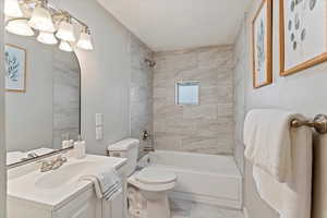 Full bath with vanity, shower / tub combination, and a textured ceiling