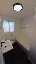 Full bathroom with vanity, dark wood-style flooring, and tub / shower combination