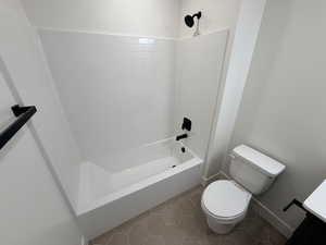 Full bathroom with bathtub / shower combination, light tile patterned floors, and vanity
