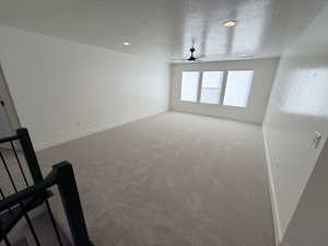 Unfurnished room featuring a textured ceiling, carpet, recessed lighting, and ceiling fan