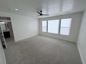 Spare room featuring a textured ceiling, recessed lighting, a ceiling fan, and carpet floors