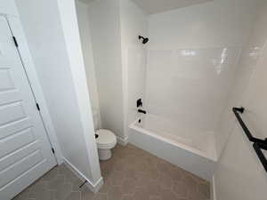 Bathroom with  shower combination and light tile patterned flooring