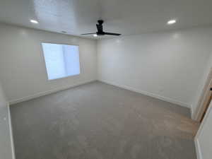 Unfurnished room featuring recessed lighting, light colored carpet, a textured ceiling, and ceiling fan