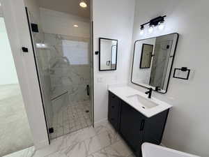 Bathroom with a marble finish shower, vanity, light marble finish floors, and recessed lighting
