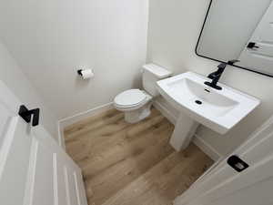 Bathroom featuring light wood finished floors and toilet