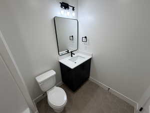 Half bathroom with vanity and light tile patterned floors