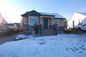 View of front of home with stone siding and board and batten siding