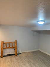 Light-toned wood-finish flooring complements the neutral wall color