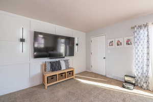 Living room featuring carpet and baseboards