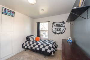 Carpeted bedroom with baseboards
