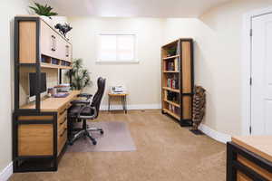 Office with baseboards and light carpet
