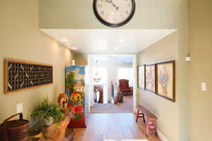 Hall featuring wood finished floors and baseboards