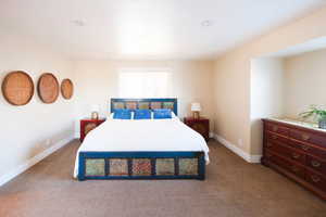 Carpeted bedroom with baseboards
