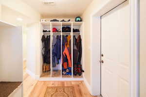 Mudroom featuring wood finished floors and baseboards