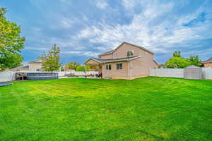 Rear view of house with a patio, a shed, and a fenced backyard