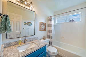 Full bathroom featuring shower / bath combo with shower curtain and vanity