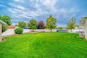 Fenced backyard with a patio area