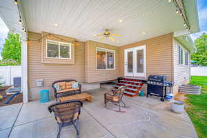 View of patio with an outdoor hangout area, grilling area, and ceiling fan