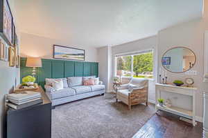 Living room with wood-type flooring and a textured ceiling