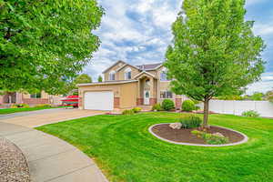 View of front facade featuring stucco siding, concrete driveway, and a garage