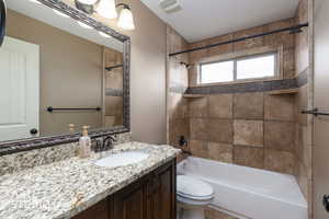 Full level 1 bathroom with tub / shower combination and vanity.