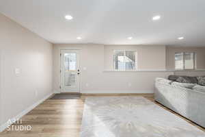 Living room with recessed lighting and light LVP flooring.  Walk out basement.