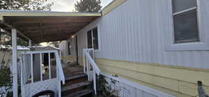 View of home's exterior with entry steps and a deck