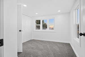 Unfurnished bedroom featuring carpet flooring, a closet, and recessed lighting