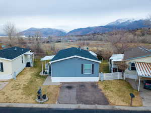 View of front of property featuring a mountain view and a shingled roof