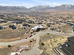 Aerial view of property's location featuring nearby suburban area and mountains