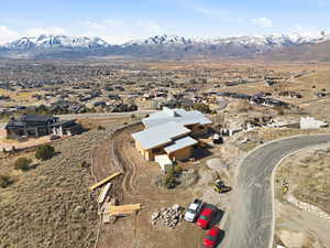 Aerial view of property's location with nearby suburban area and mountains