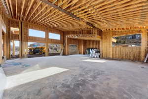 View of 5 car garage with large ceilings and lots of windows