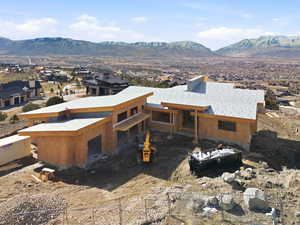 Back of house featuring a mountain view and a residential view