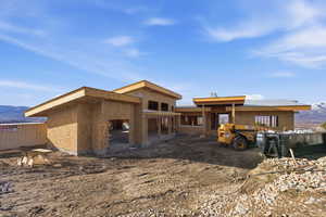Back of house with a mountain view and an outbuilding