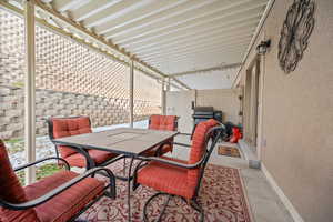 View of covered patio with outdoor dining area.