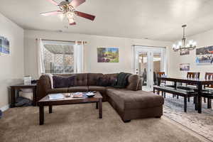 Spacious family room with large window, french patio doors, and kitchen dinette.