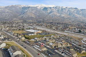 Aerial view of property's location featuring nearby suburban area and mountains.