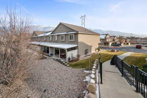 View of back of property featuring stairs to upper exterior level.