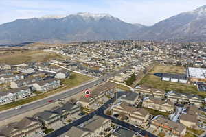 Aerial view of property's location featuring nearby suburban area and a mountain backdrop.
