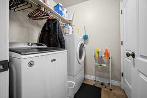 Laundry room with separate washer and dryer and storage closet.