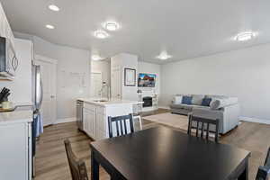 Dining area with a fireplace and light wood-type flooring