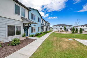 View of community featuring a residential view, a yard, and a playground