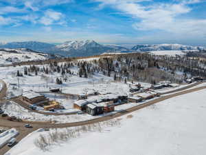 Snowy aerial view featuring a mountain view