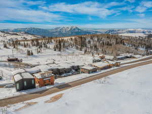 Snowy aerial view featuring a mountain view