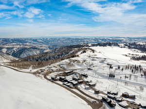 Snowy aerial view featuring a mountain view