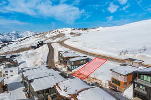 Snowy aerial view featuring property boundaries highlighted and a mountain view