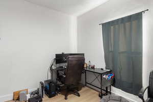Bedroom with light wood-style floors and baseboards