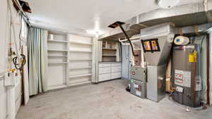 Utility room with gas water heater and heating unit