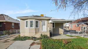 View of front of home featuring a gate and a patio