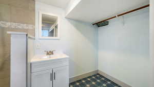 Bathroom featuring vanity and baseboards